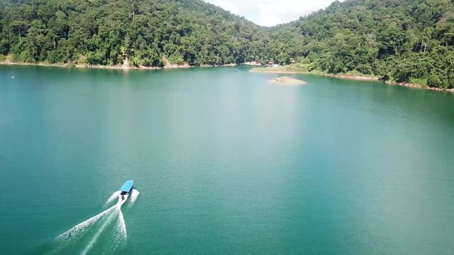 Aerial: Speedboat cruising on a beautiful lake, Malaysia