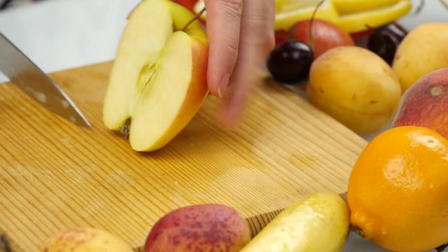 housewife at home preparing fresh salad slicing apple fruits on cutting board. vegetarian healthy food and dieting concept. 4K