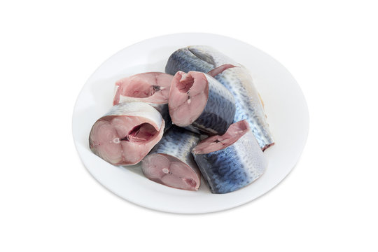 Pieces of uncooked Atlantic chub mackerel on the white dish