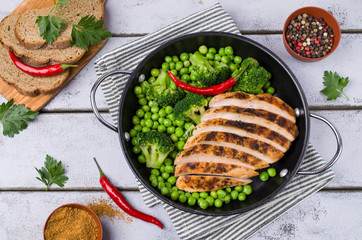 Fried chicken breast with green vegetables