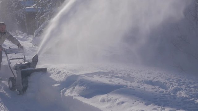 Man Snowblowing deep snow