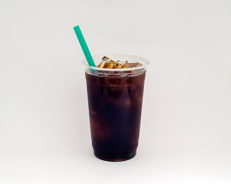 Iced Cold Brew Coffee With A Green Straw On White.