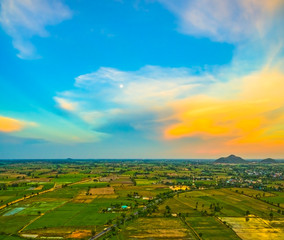 Fototapeta na wymiar aerial view scenery sunset on new route pass in the rice field. under construction new motorway connect to Myanmar.