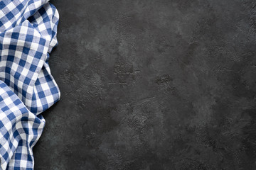 Black concrete background with blue checkered textile. Food background for recipe, cooking...