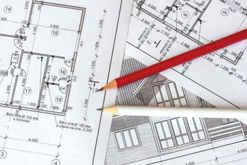 The architectural plan of the house is printed on a white sheet of paper. A red and  white pencil on it. June 2018, Russia, Moscow