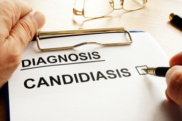 Doctor is holding form with Candidiasis.