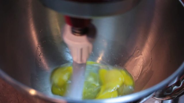 Making breakfast muffins in the electric mixer. Eggs, water, oil and flour can be seen being mixed in