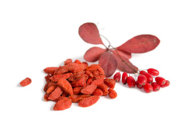 Branch of ripe red barberries and dried goji berries isolated on white background