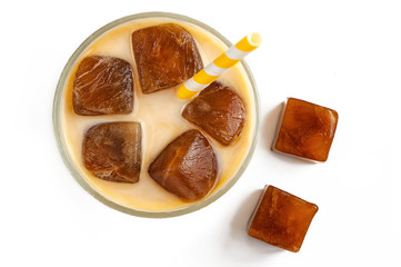 Milk coffee cocktail from frozen coffee cubes isolated on white background. top view