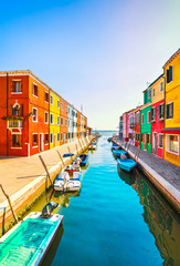 Venice landmark, Burano island canal, colorful houses and boats, Italy
