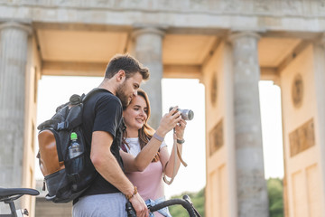 low angle view of woman showing photo camera to boyfriend at Pariser Platz, Berlin, Germany © LIGHTFIELD STUDIOS