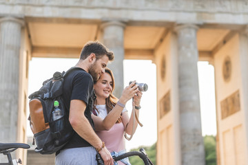 low angle view of woman showing photo camera to boyfriend at Pariser Platz, Berlin, Germany