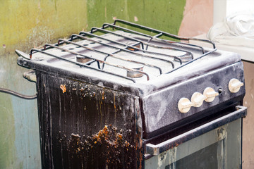 Old dirty gas stove in an abandoned state