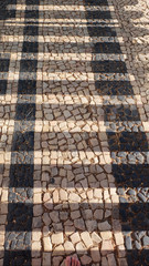 Tiled stone pavement with stripe pattern and different colors in Portugal