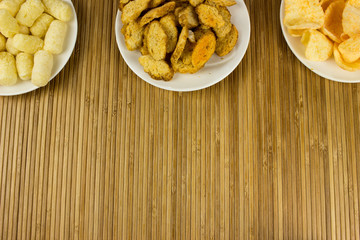 Snack,  potato chips  on a plate. Wooden table. Salty food for beer