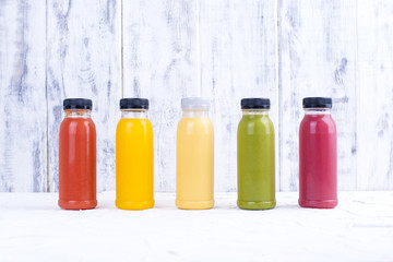 Fototapeta na wymiar Organic cold-pressed raw vegetable juices in glass bottles. Vitamin and healthy food. Copy space.,