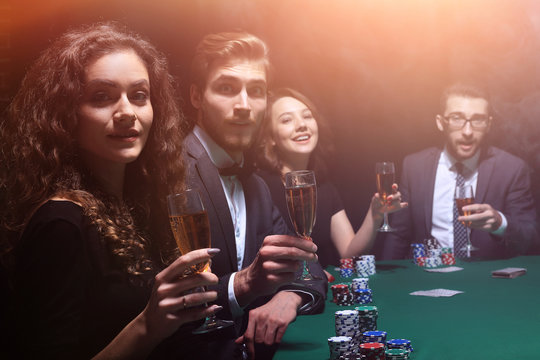 poker players sitting at a table in a casino