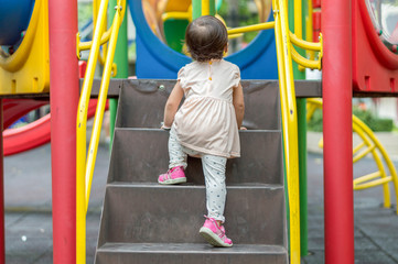 Asian baby girl are climbing the stairs.