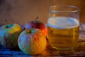 Three apples and a glass of cider