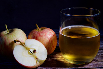 Three apples and a glass of cider