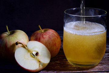 Three apples and a glass of cider