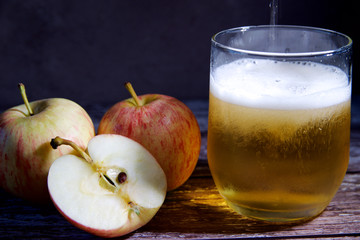 Three apples and a glass of cider