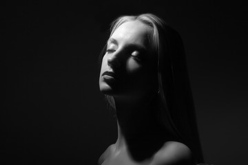 Portrait of a beautiful blonde on a black background.