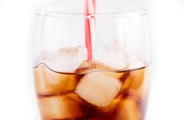 Cola in glass with straw and ice cubes isolated on white background. Soda with bubbles isolated on white. Refreshing non-alcoholic drink