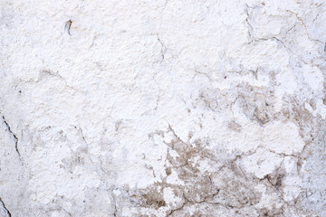 Closeup fragment of white shabby stone wall
