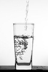 Water pouring into the clear glass