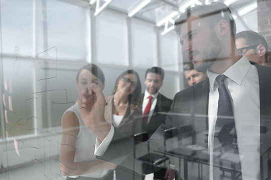 businessman and business team look through the window of a modern office.