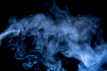 Fototapeta premium Blue smoke isolated on black background.