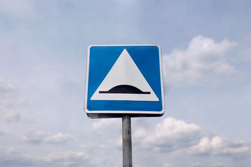 Road blue speed bump sign on sky background