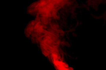 Red smoke isolated on black background.