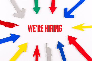 Colorful Arrows Showing to Center with a word WE'RE HIRING