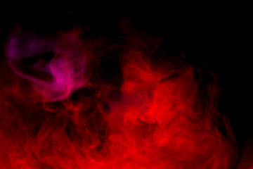 Red smoke isolated on black background.