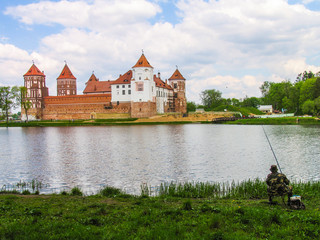Obraz premium Mir, Belarus. Castle Complex Mir On Sunny Day with blue sky Background. Old medieval Towers and walls of traditional fort from unesco world heritage list