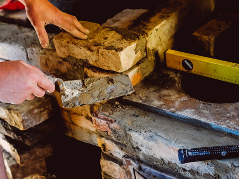 Restoration repair of the old village furnace. Bricklaying.