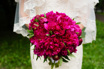 Wedding bouquet of flowers in the hands of the bride