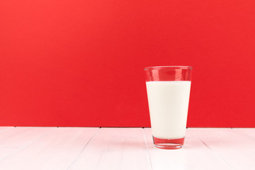 milk glass with red background and copy space