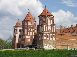 Fototapeta na wymiar Mir, Belarus. Castle Complex Mir On Sunny Day with blue sky Background. Old medieval Towers and walls of traditional fort from unesco world heritage list