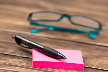 business workplace with glasses, calculator and pen