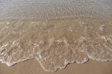 Soft waves on sandy beach