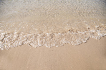 Fototapeta na wymiar Soft waves on sandy beach