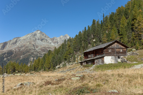 A Closed Cowshed At Fall In Front Of A Mountain Meadow Stock