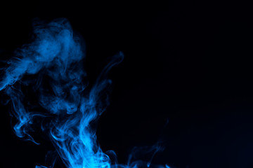 Blue smoke isolated on black background.