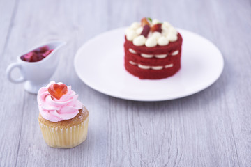Cupcake and cake on wooden background