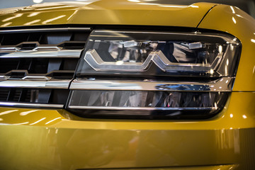 headlight of modern yellow car with led and xenon optics