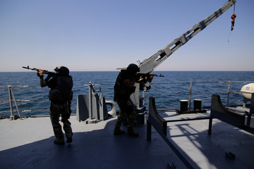 Romanian special forces marines are dropped in a rubber speed boat from the ‘Regele Ferdinand’ frigate,