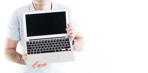 A man in white T-shirt shows his empty laptop screen. Isolated on white background, No face. Horizontal banner with copy space.